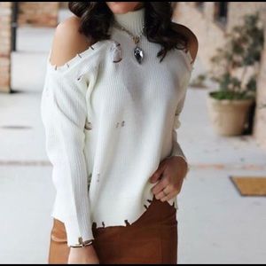 Distressed cold shoulder sweater
